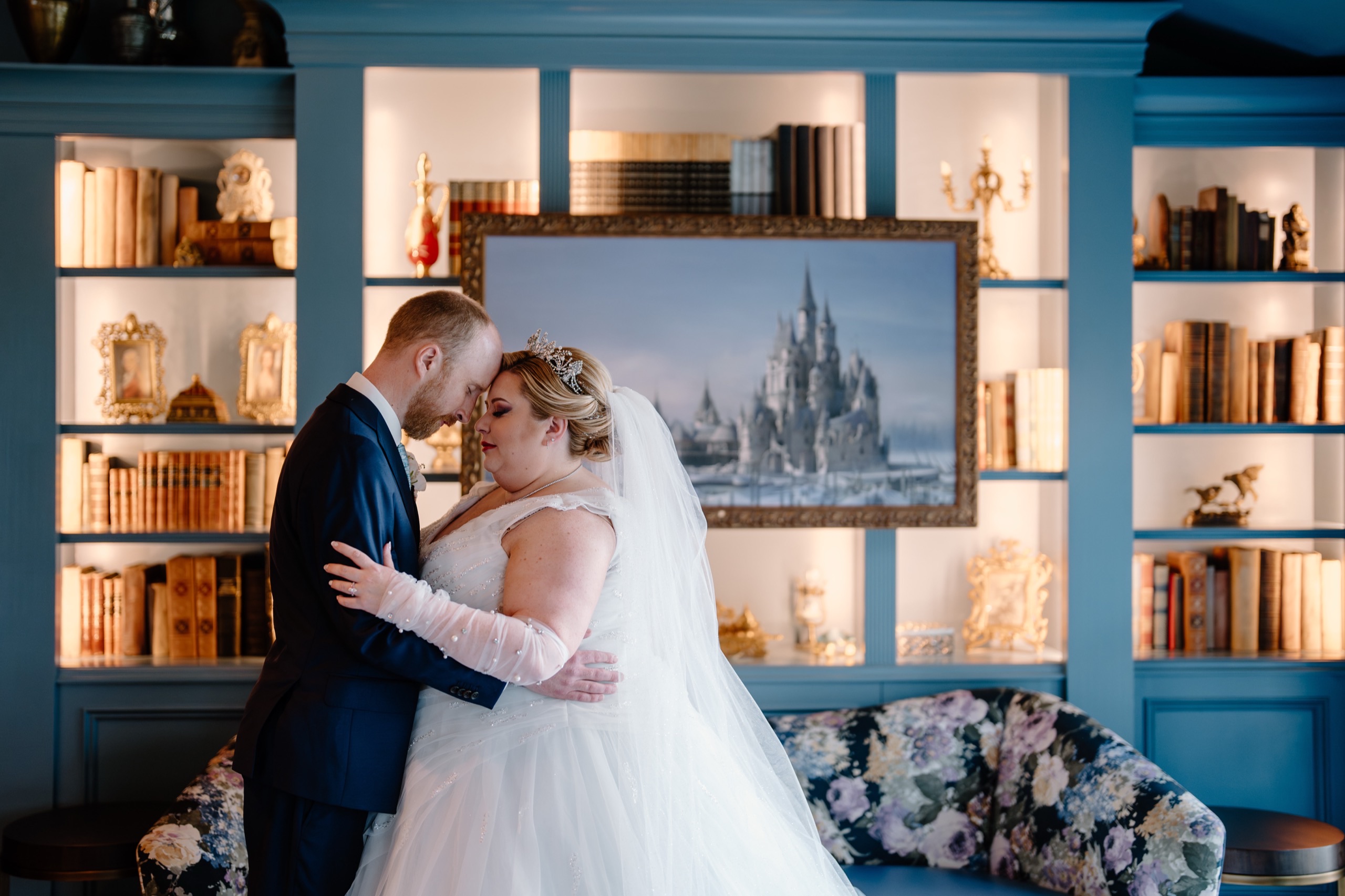Bride and groom sharing a quiet first look moment in a candlelit library