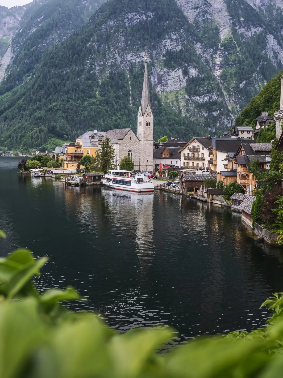 The lakeside village of Hallstatt and its church spire below the mountains, Austria