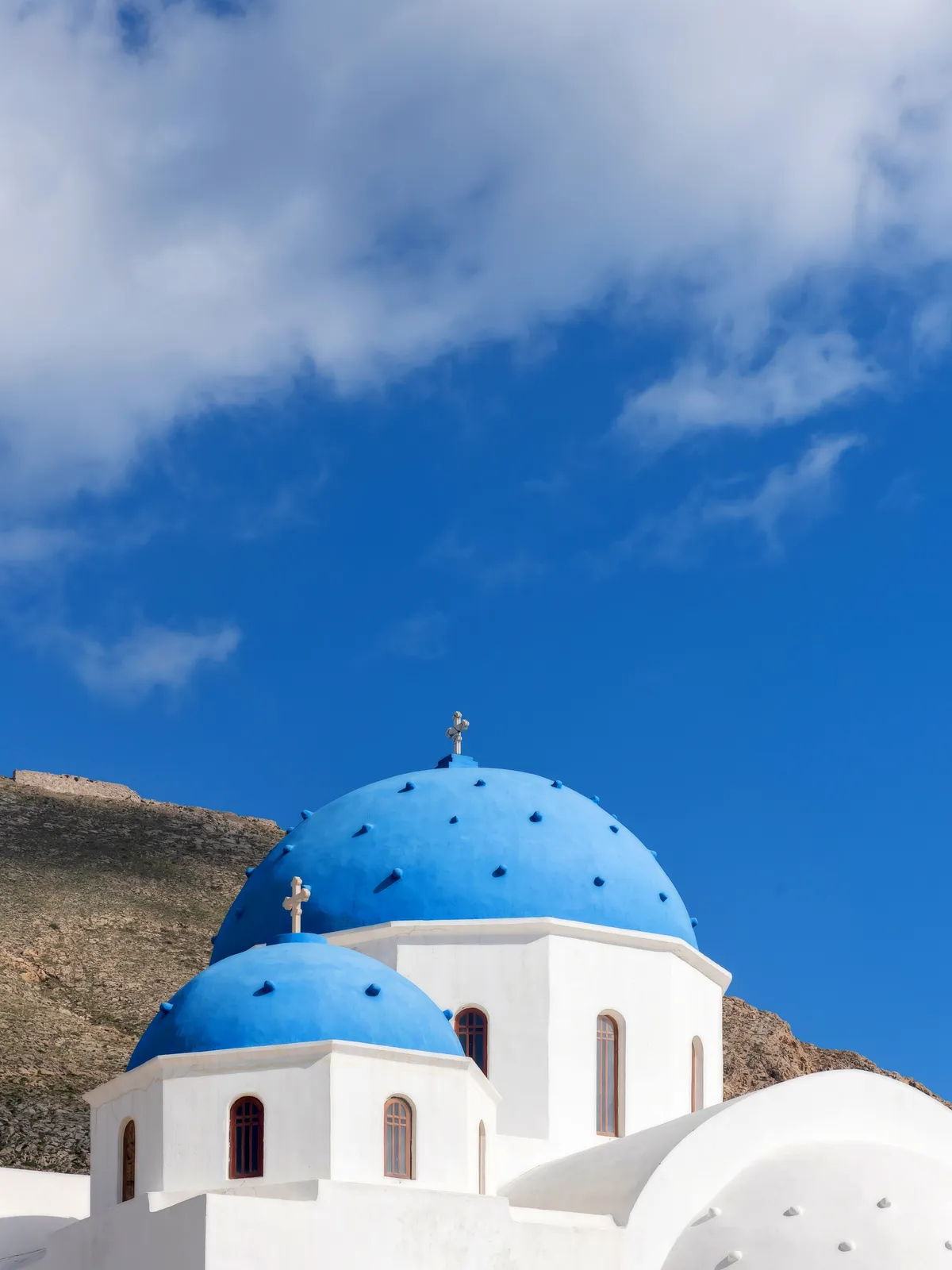 Blue-domed churches and whitewashed buildings in Oia, Santorini, Greece