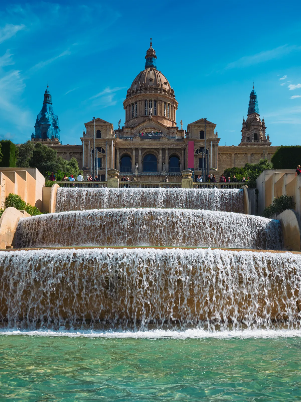 The Magic Fountain of Montjuïc cascading below the National Palace in Barcelona, Spain
