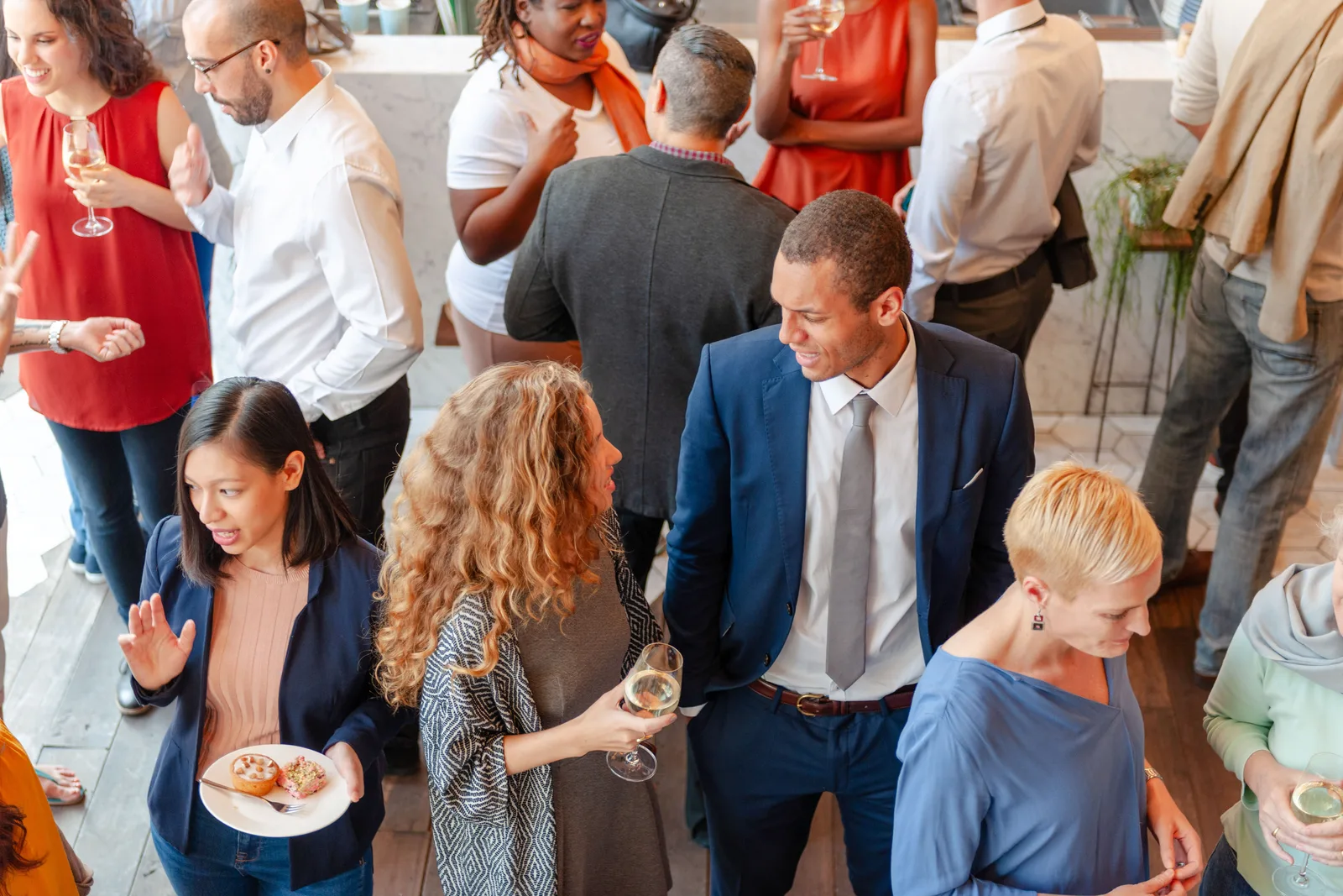 Guests mingling with drinks at a corporate networking event